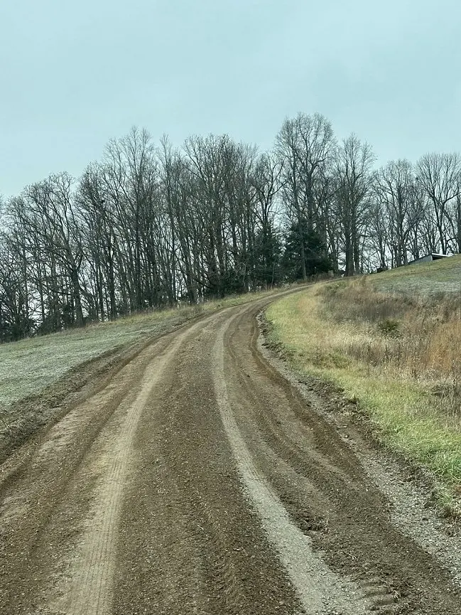 SJ Perry Hauling job in April 2026 before photo of a new muddy driveway prior to adding gravel and rock border